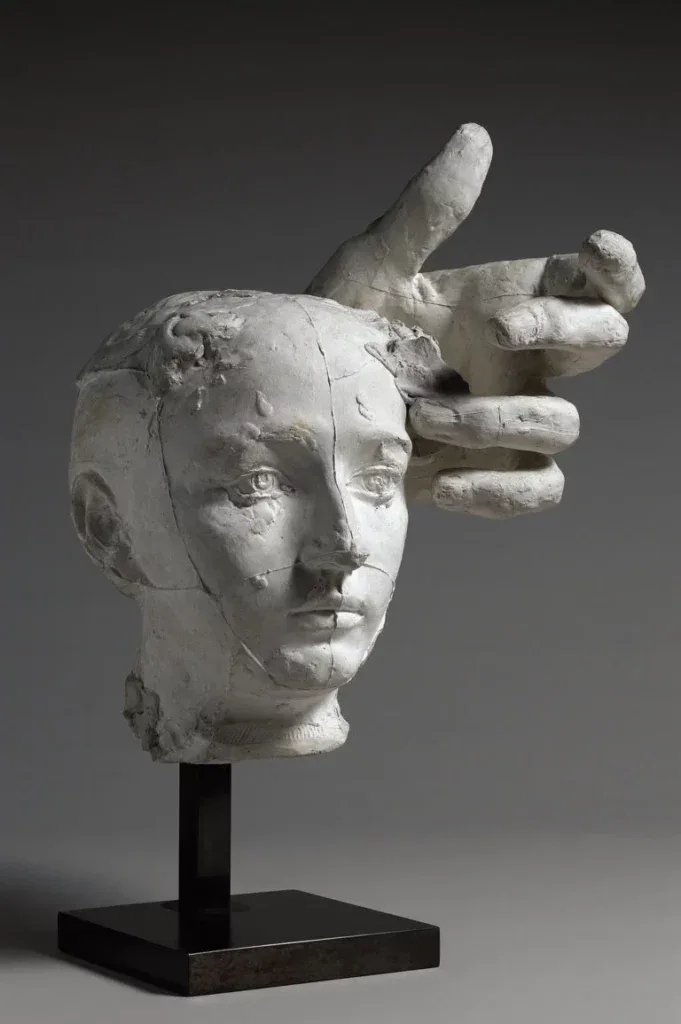 Auguste Rodin sculpture — head and hand study demonstrating the abattis method of separately modeled members